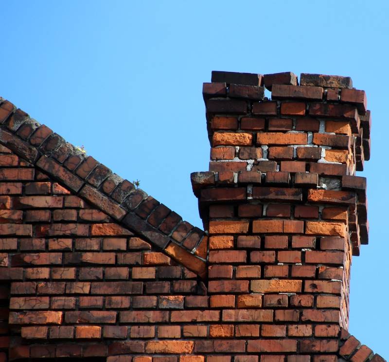 Signs Your Owings Mills Home Needs a Chimney Inspection Damaged chimney on an Owings Mills home showing cracks and missing mortar